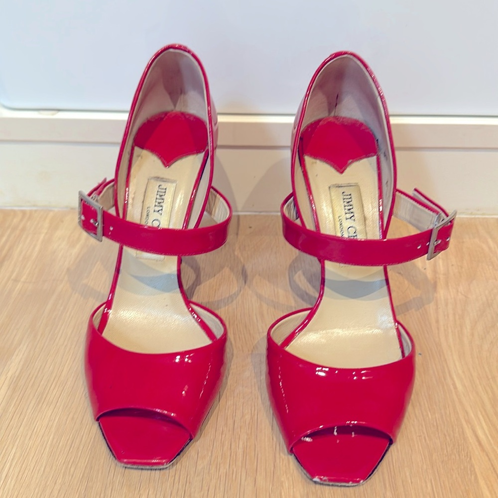 Jimmy Choo neon pink patent peep toe heels.